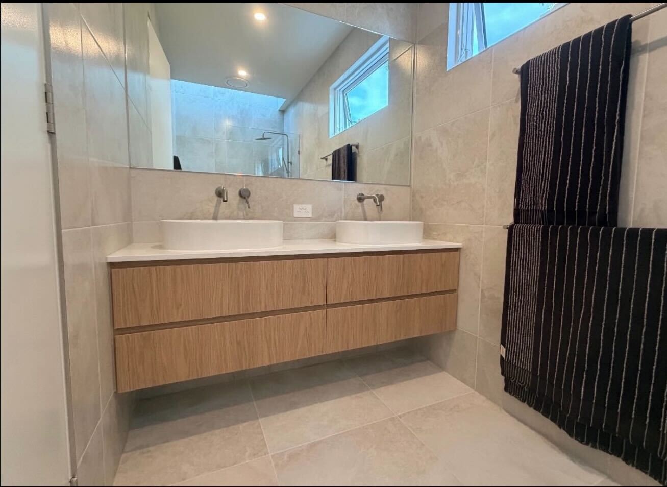 Bathroom with timber double vanity, stone benchtop and white tile